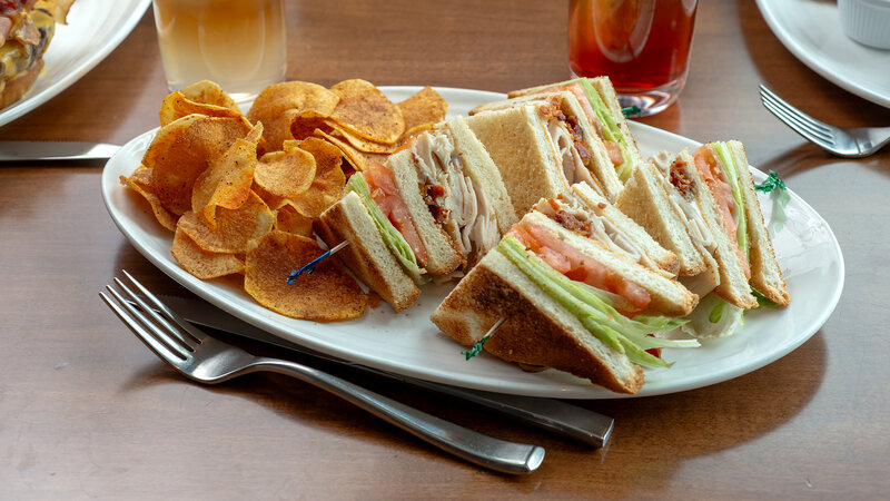 BLT club sandwich with side of potato chips