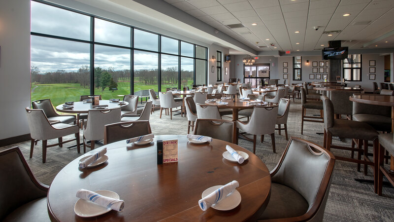 Dining room with many set tables and view of outside