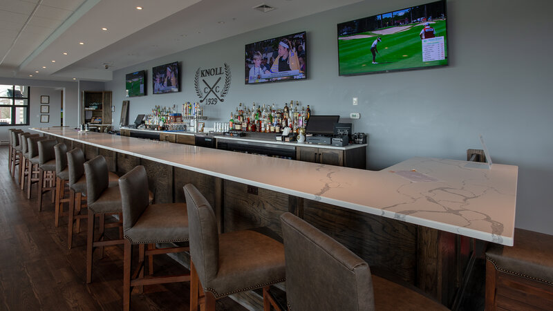 Bar in dining room with many high back chairs